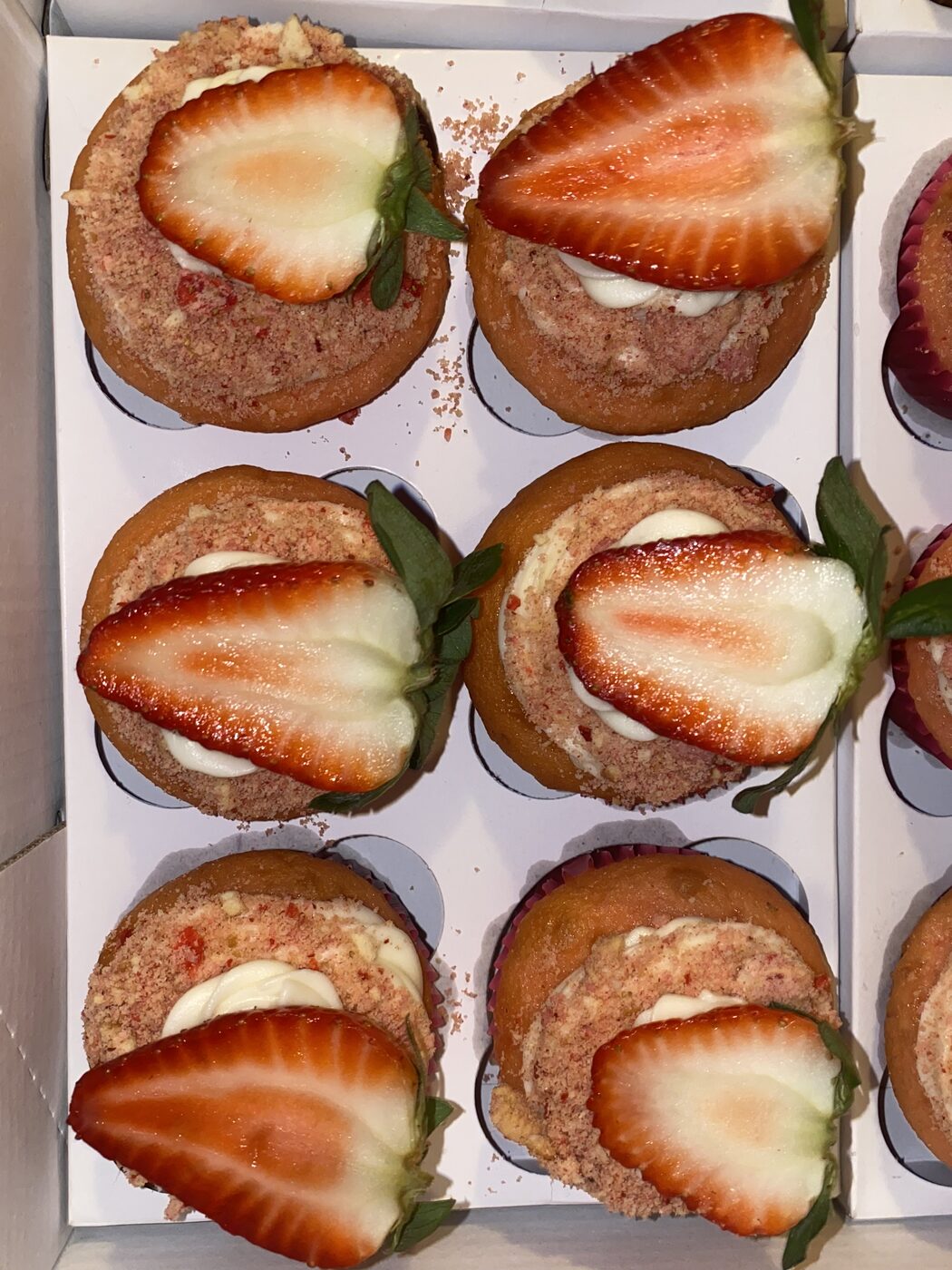 Strawberry shortcake cupcakes topped with fresh strawberries